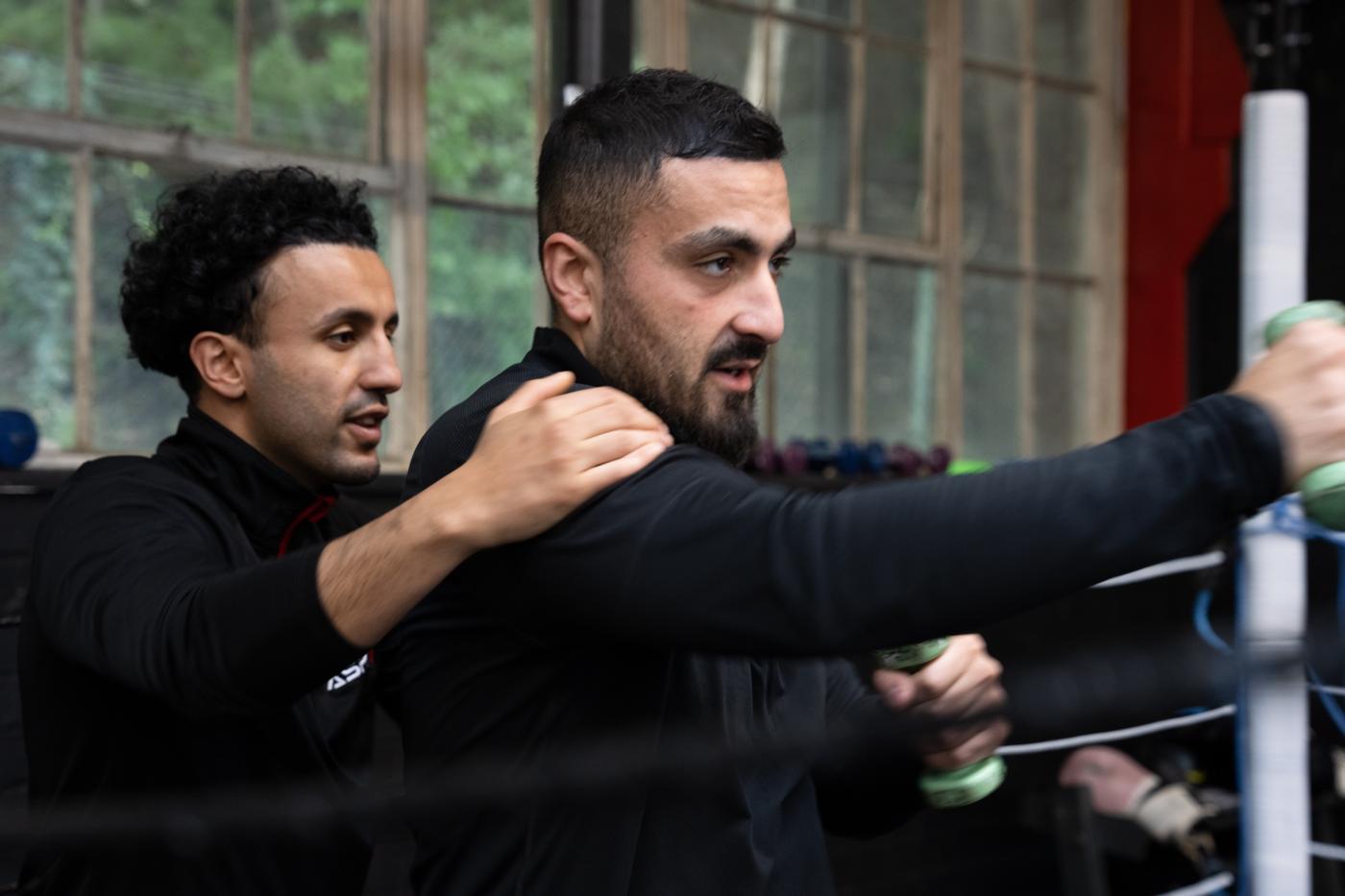 Coach correcting a member's technique